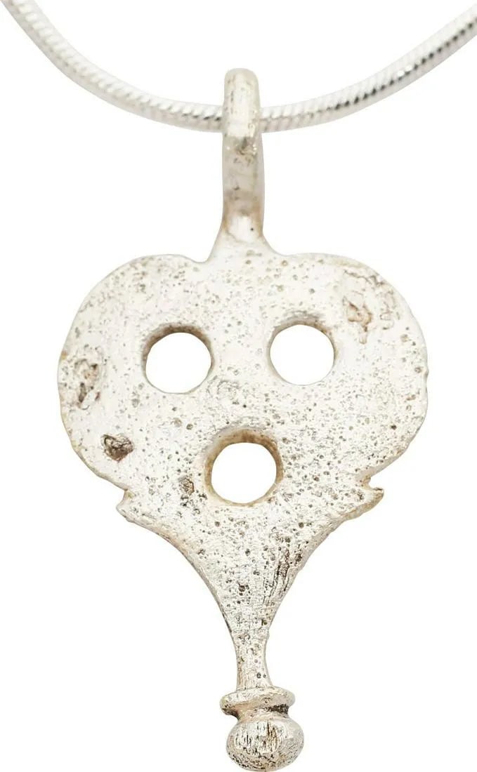 ROMAN LEGIONARY ARMOR MOUNT, 100-300 AD: Gilt bronze, about 1 3/8" height of spade form, delicately pierced and scalloped, with lobed terminal. Fastened to the laminar belt like leather protection for the area below the belt, the pteruges.