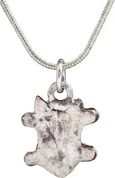 MEDIEVAL EUROPEAN NOBLE WOMAN'S PENDANT NECKLACE: English or French (Norman). Silvered bronze, shield-shaped, about 3/4" height flanked by pairs of nubs. Broad raised edge and a central armorial device, obscured by wear and burial. Made by the open m