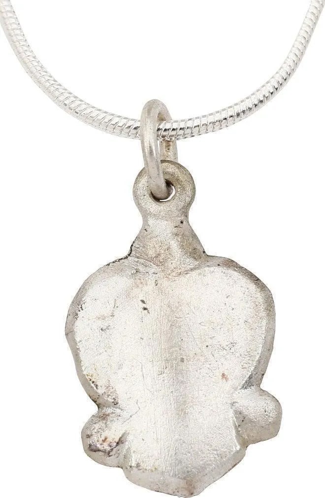 MEDIEVAL SCANDINAVIAN NECKLACE PENDANT: About ¾” height. Post Viking, dating about 1200 AD. Form deriving directly from the earlier heart pendants with cusped swelled top. The lower portion blunted under a pair of transverse proj