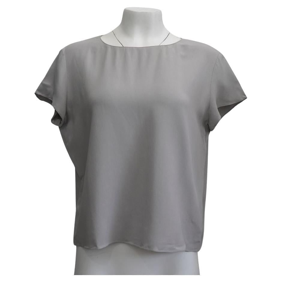 The Row Grey Blouse sz 6: The row grey blouse Size 6 Length: 22.5” Bust: 44" perfect condition, no defects Reserve: $260.00 Shipping:Domestic: Flat-rate of $85.99 to anywhere within the contiguous