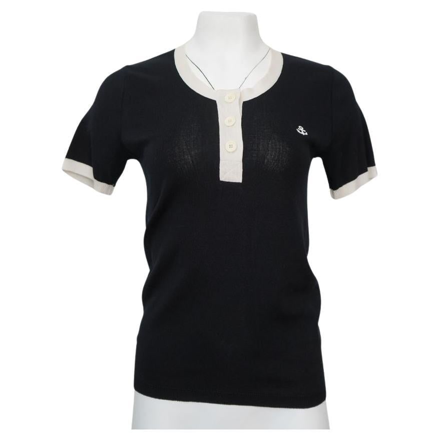 Sonia Rykiel Black & Cream Cotton Button Anchor Polo Top: Sonia Rykiel Black and Cream 3 button top. Cream border detail along the collar, buttons, and sleeves. Has a repair on front of shirt, about an inch from the anchor (photo). Bust 32" Waist 30" Length
