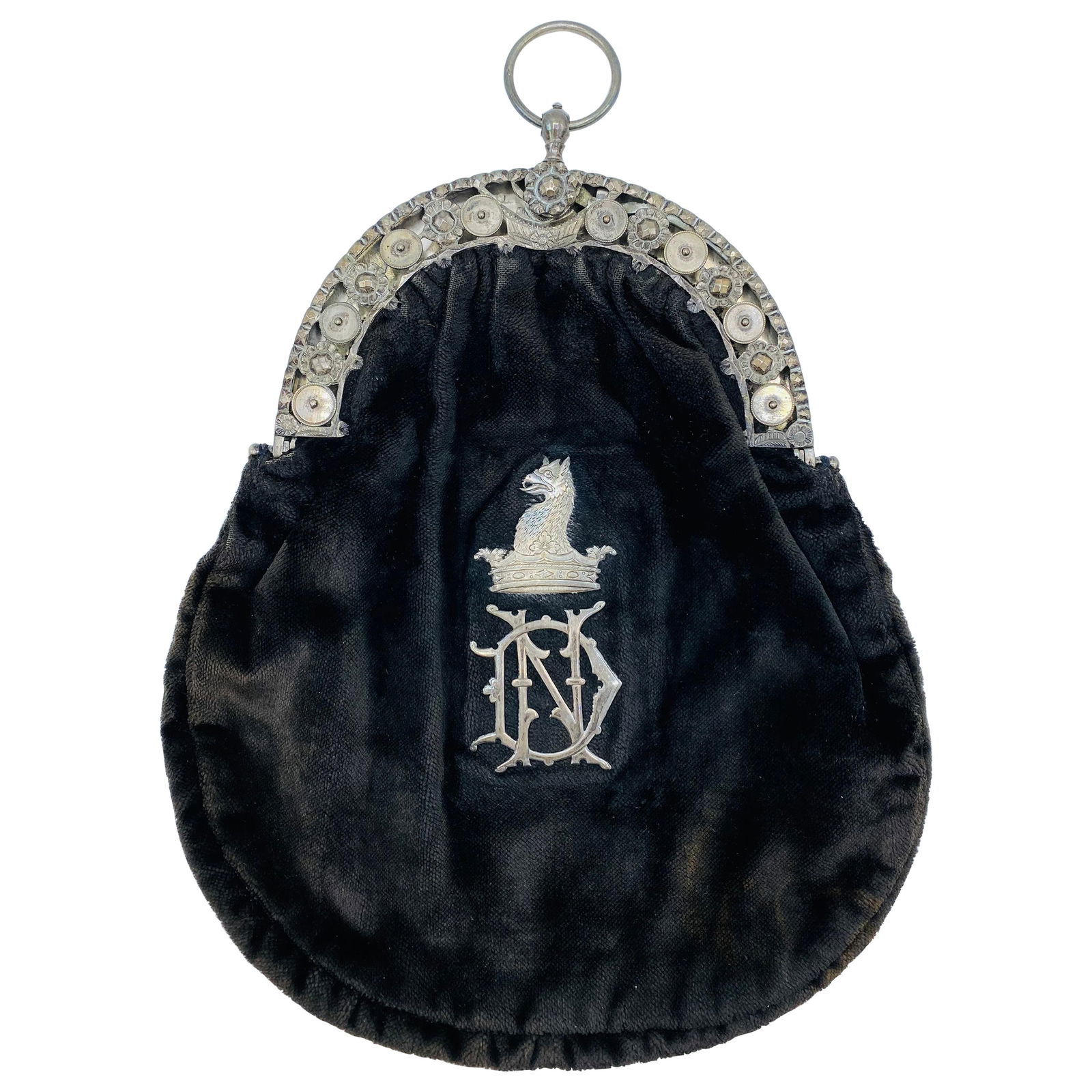 Victorian English Sterling Silver and Brown Velvet Evening Purse: Product details: Circa 1900's. Dark brown velvet with silver design details. Featuring sterling silver 3D floral motif, griffin detail on the front with ND monogram. Total weight is 262.1 grams. Reser