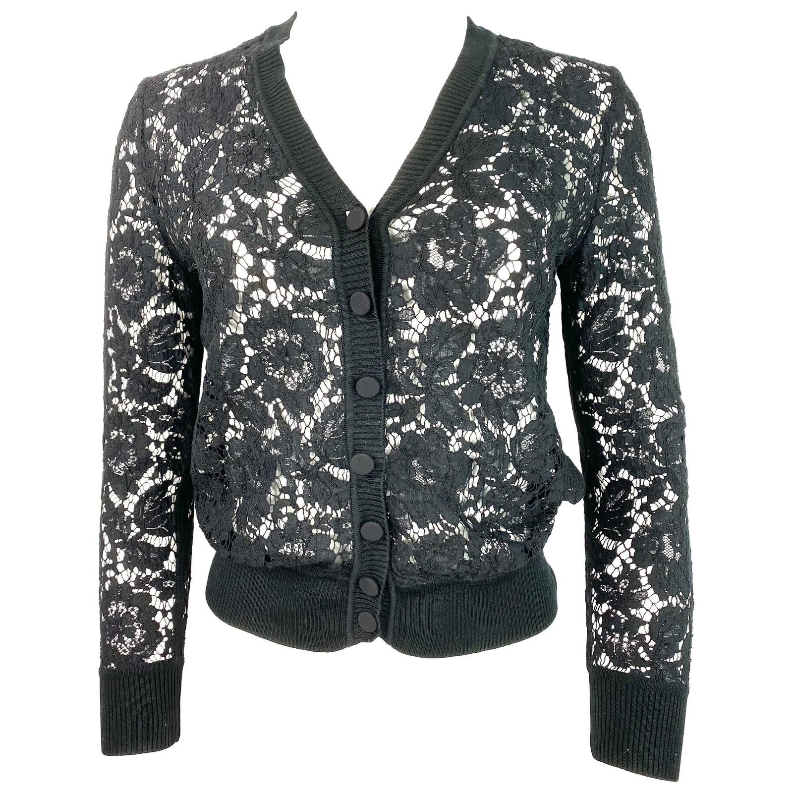 Valentino Black Lace Cardigan Top: Product details: Featuring black floral lace, see through, V-neck line, front button closure, black knit trip detail. Made in Italy. Reserve: $552.00 Shipping:Domestic: Flat-rate of