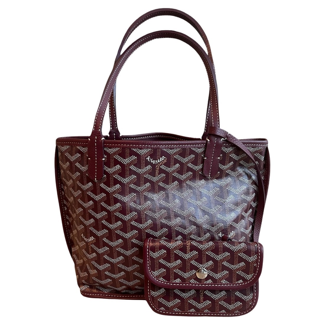 Goyard Burgundy Anjou Mini Shoulder Tote Handbag: This Goyard burgundy Anjou mini bag doesn’t need an introduction. The tote is recognizable from the distance by its shape. Goyard pattern is another well-known element. It’s been around