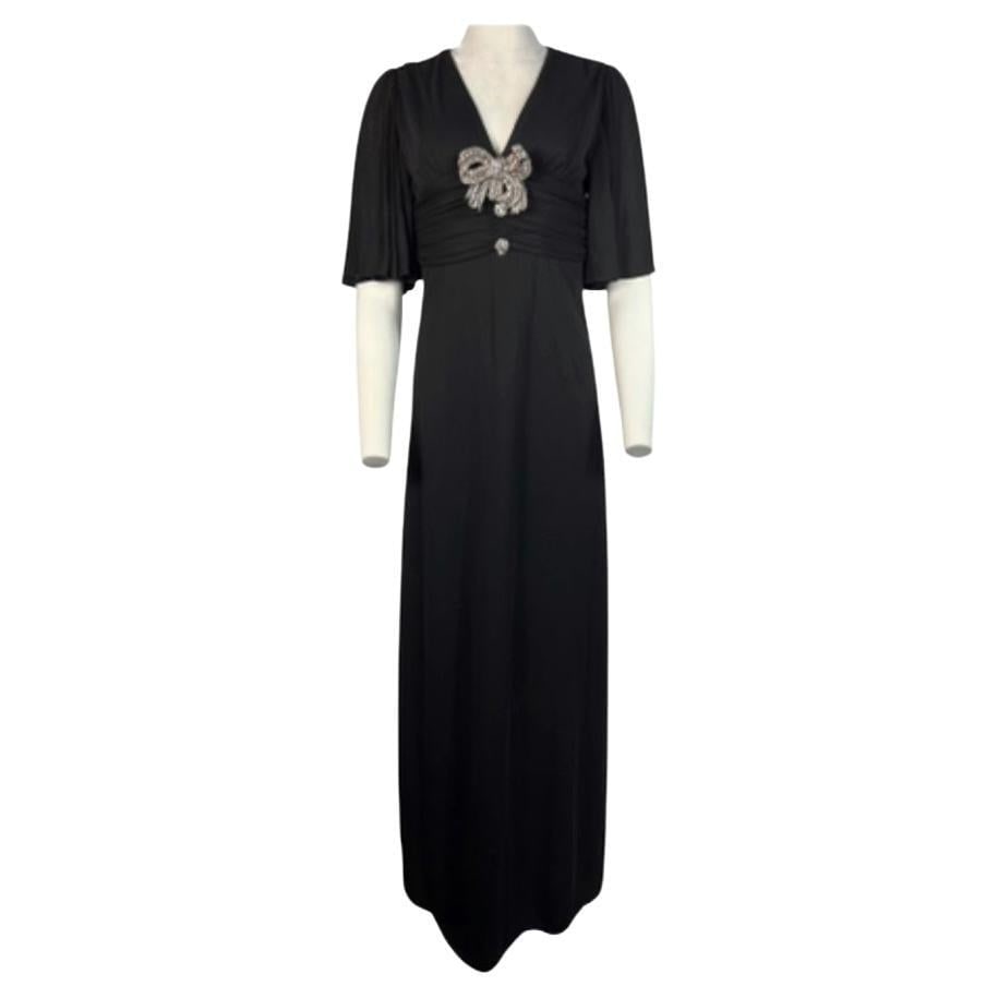 Gucci Black Rayon and Silk Maxi Dress Gown w/ Crystal Bow, Size Small: A gorgeous Gucci maxi dress gown, made of rayon and silk, size small. This opulent dress features a few remarkable details that make this dress to look as a statement. The dress is adorned with a crys