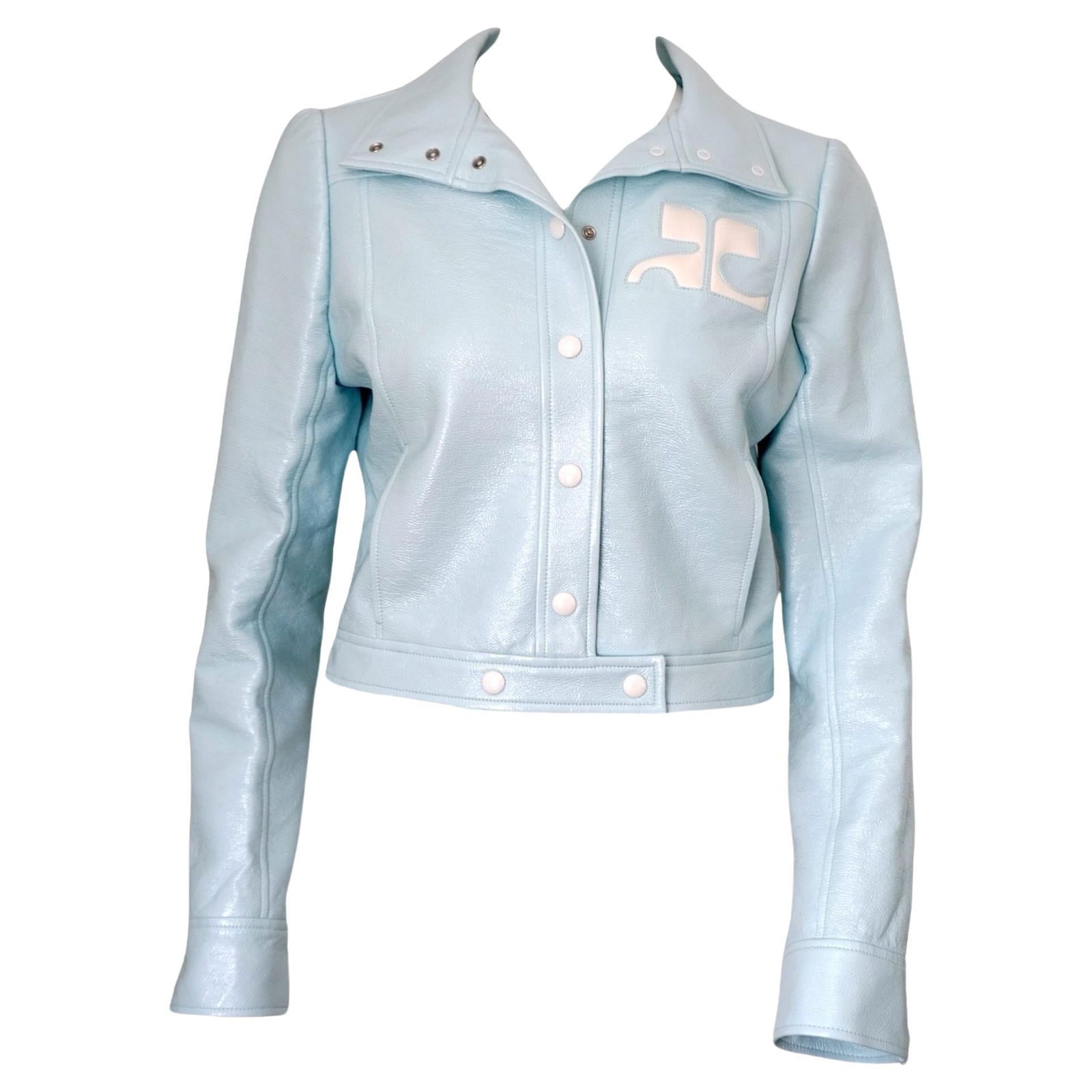 Courrèges Logo Cropped Blue Vinyl Buttoned Jacket sz 42: Pastel Blue vinyl jacket from COURRÈGES featuring a cotton blend, embroidered logo at the chest, spread collar, long sleeves, front button fastening and two side slit pockets. Size 42 Comes with