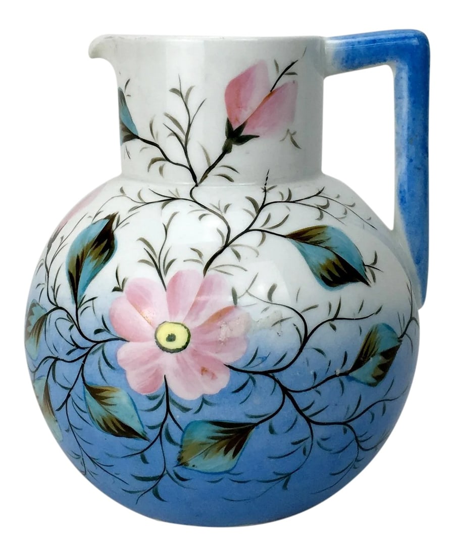 20th Century Traditional Blue & White Floral Pitcher: This vintage, authentic porcelain blue pitcher features a lovely pink flower motif. Condition: Alterations: Original Condition Unaltered Imperfections: Some Imperfections Condition Notes: In Good