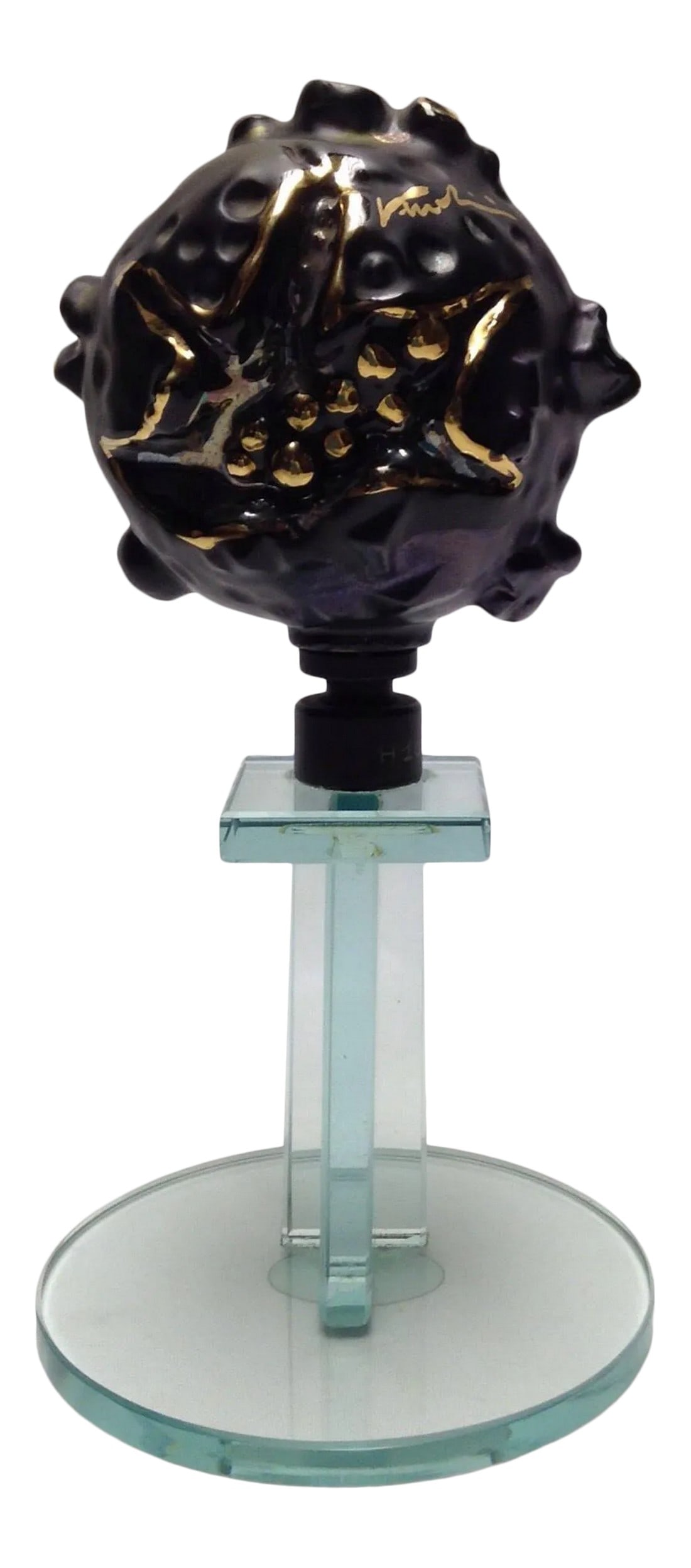 Abstract Art Object Sculpture by Veruolini Verzolini: A sculpture signed by artist Veruolini Verzolini black gold platinum on a clear green glass pedestal. The artist signature is on the front. The adhesive label is on the bottom adhered to it. Looks