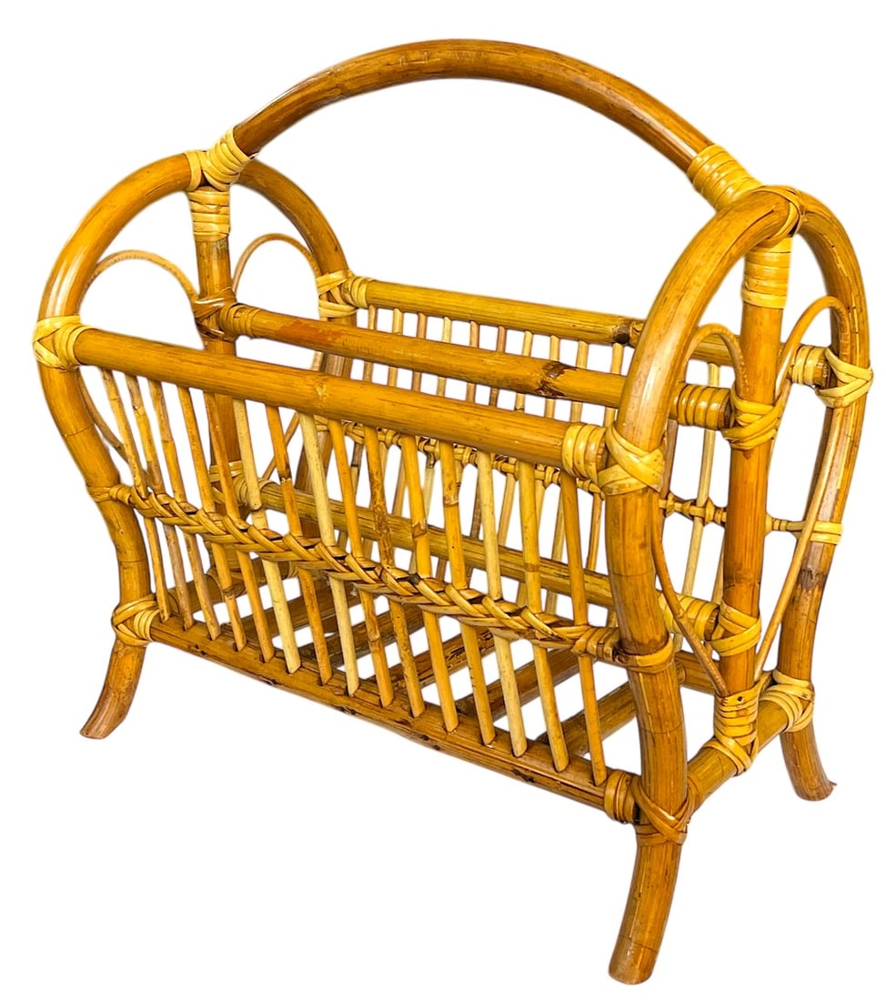 1970s Large Mid-Century Bamboo Bentwood Rattan and Leather Magazine Rack: Beautifully crafted rattan and bamboo magazine rack, a perfect blend of natural materials and sculptural design. Featuring a double-sided cradle with intricate vertical weaving and arched handles,