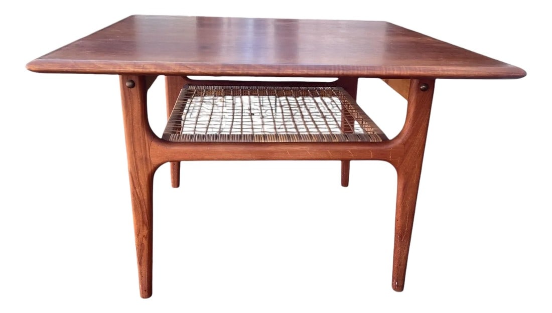 1960s Mid Century Modern Trioh Danish Modern Teak Table With Makers Mark.: Trioh Danish Modern two tier table with woven cane magazine shelf and makers mark. In very good vintage condition. Condition: Alterations: Original Condition Unaltered Imperfections: Some