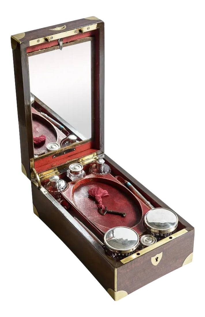 Military Officer's Fitted Campaign Box: English C.1820, Mahogany officers traveling box in the campaign style with brass corners and a brass plaque inlaid on the top. The interior is fitted with a large selection of lidded glass jars and
