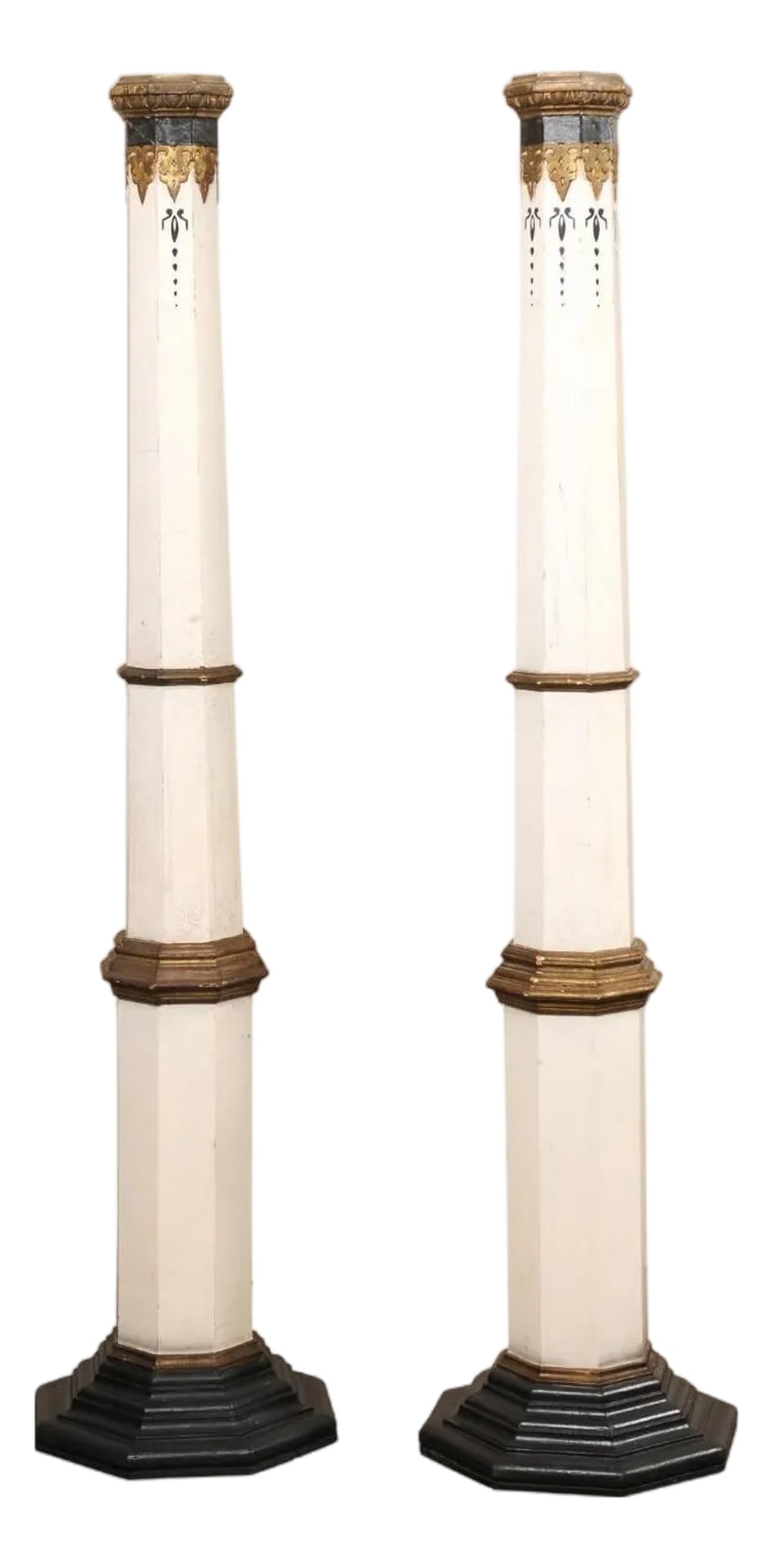 Pair Spanish Tall Architectural Columns: A pair of tapering, painted Spanish wood columns from the early 20th century. This tall pair of antique pillars from Spain, each with a hand-painted, decorative finish, have octagonal-shaped and taper