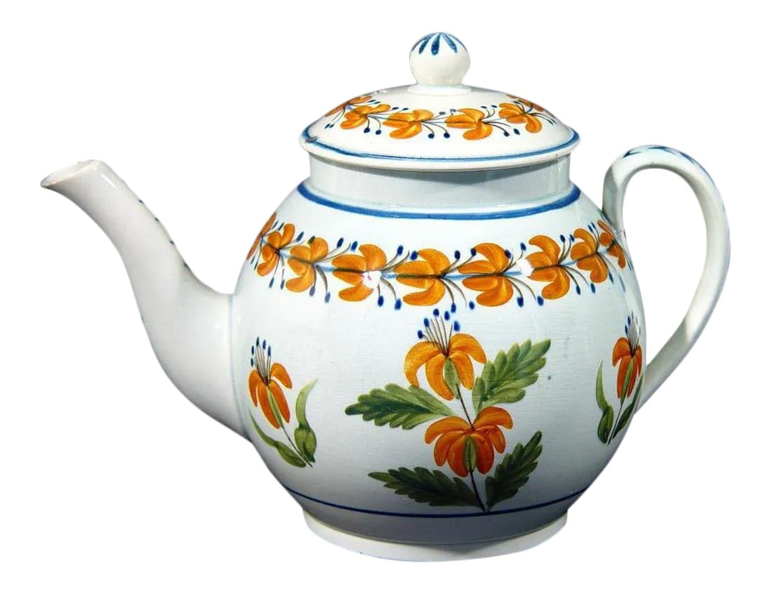 English Pottery Pearlware Teapot Decorated With Prattware Orange Flowers: A charminFolk Blossom: Prattware Pearlware Teapot Object: Teapot and Cover Origin: Staffordshire, England Date: Circa 1810-1820 Medium: Pearlware Earthenware with High-Fired Enamel Colors Dimensions: