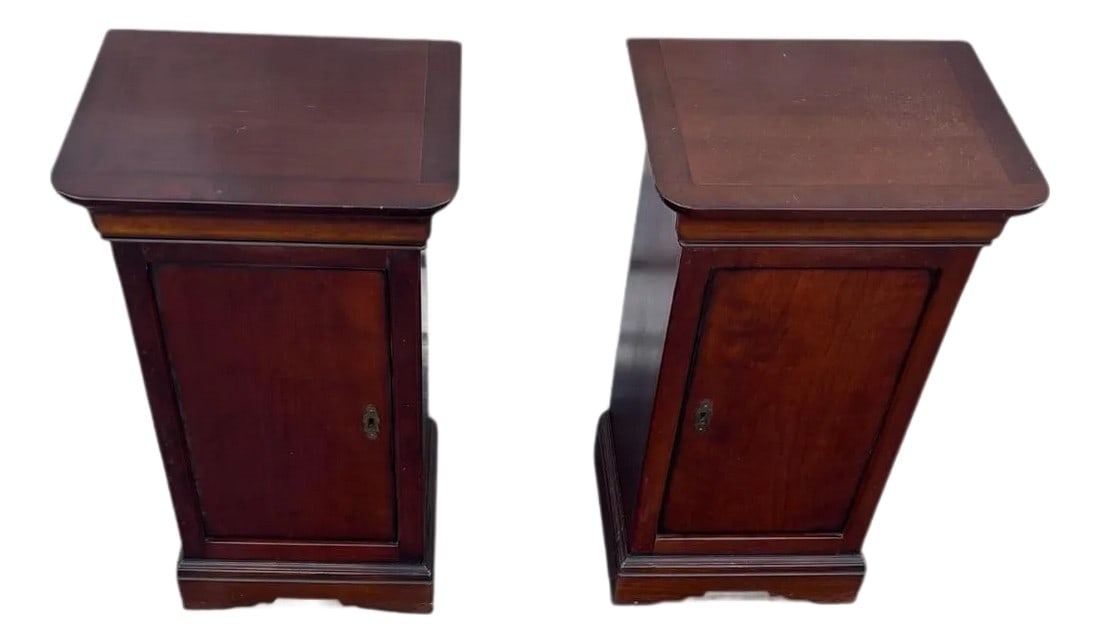 1940s Pair of French Empire Style Bench Made Mahogany Side Cabinets With Hidden Top Drawer. Made in: Pair of French empire style bench made mahogany side cabinets. The top resting on ogee molded frieze atop case with single shelf, enclosed by single blind panel door raised on bracket feet lockable