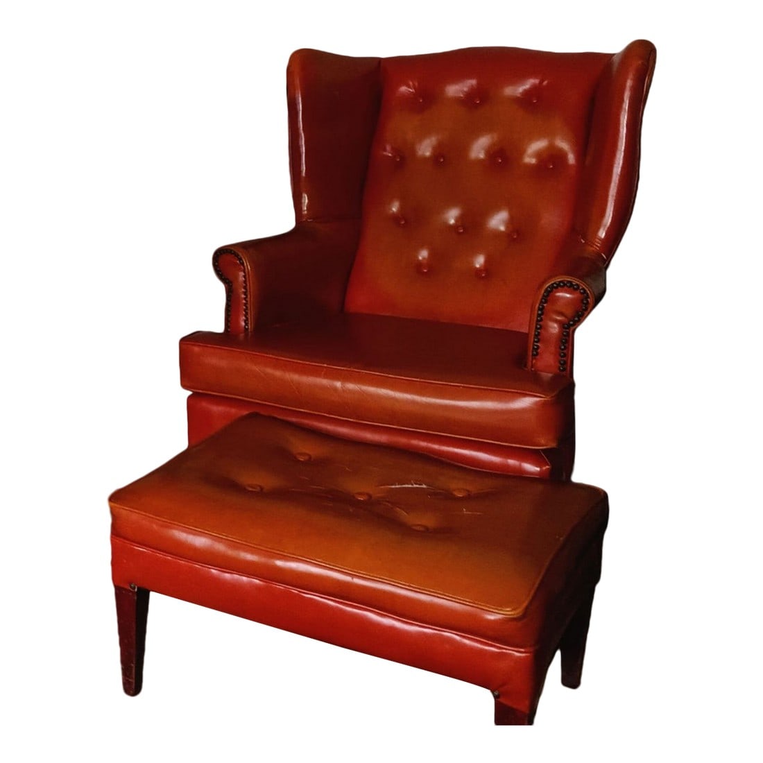 1960s Mid-Century Burnt Orange Armchair & Ottoman: Presenting a true gem of Mid-Century modern design – a stunning armchair and matching ottoman in the Chesterfield style. With its unique tapered legs and button-down seat cushion, this rare