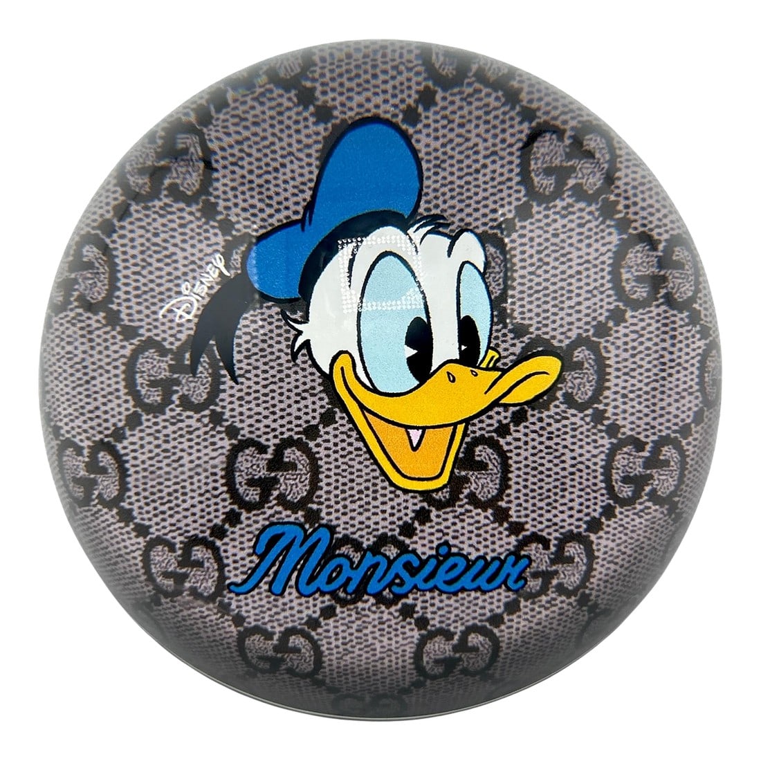 Gucci X Disney Donald Duck Monsieur Glass Paperweight: Rare find from Gucci X Disney! Features the classic Gucci logo in the background. Blue leather backing with Gucci logo- made in Italy. Measures 3.78" diam. Condition: Alterations: Original