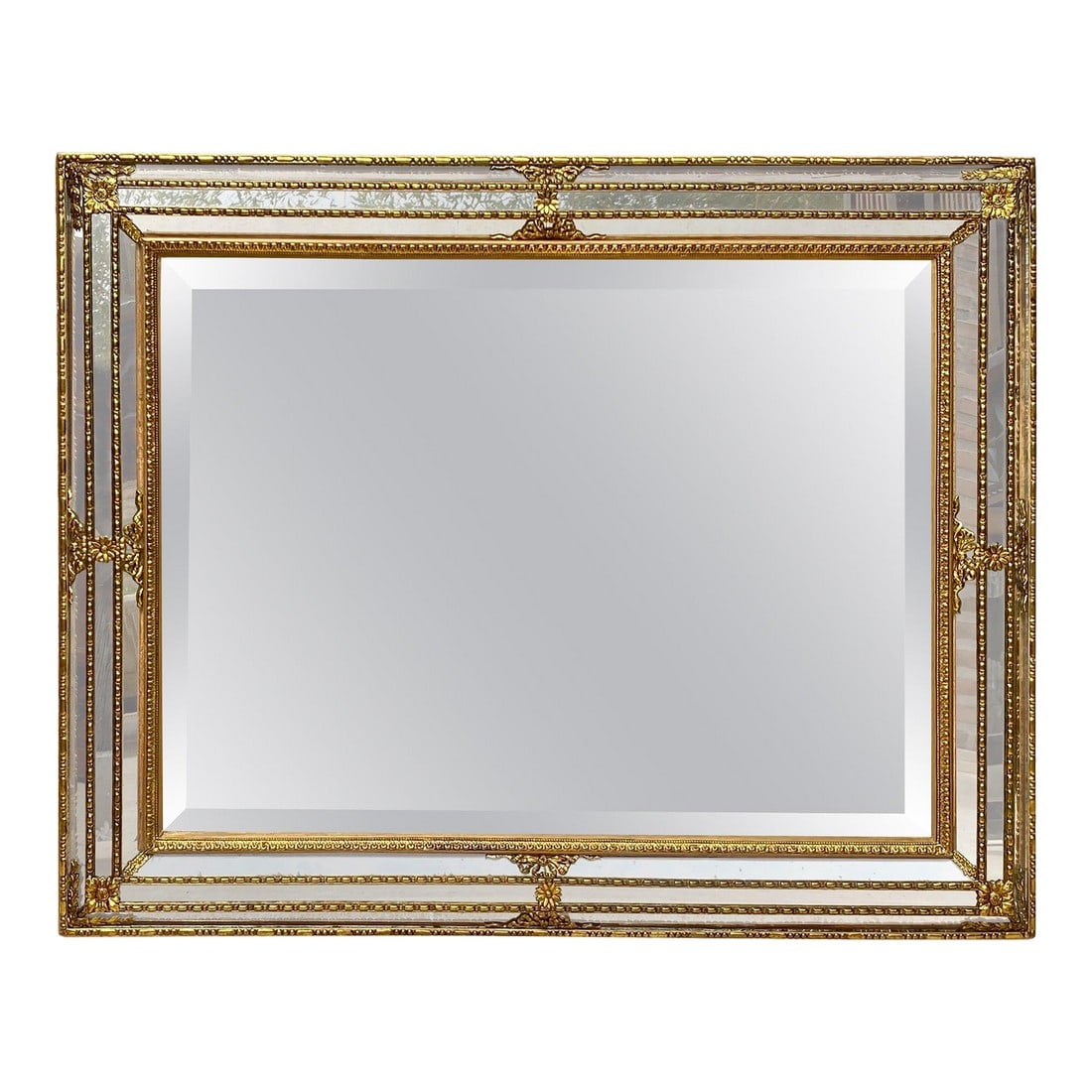 French Directoire Gilded Carved Wood Wall Mirror, 1940s: This is a beautiful gold leaf mirror. The mirror is carved wood and not plaster. The gold is very well done and has a great patina. The mirror dates from the 1940s.A Venetian mirror in the classical s