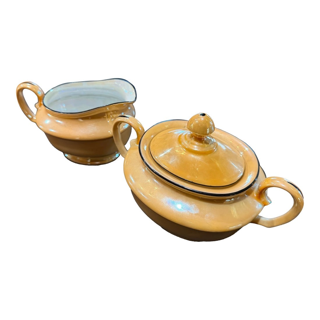 Vintage Art Deco Czech Lusterware Sugar and Creamer Set by Bell China, Czechoslovakia: A beautiful Art Deco era sugar and creamer set produced by Bell China in Czechoslovakia, featuring a warm peach/butterscotch lusterware glaze with subtle iridescent sheen and contrasting black trim.