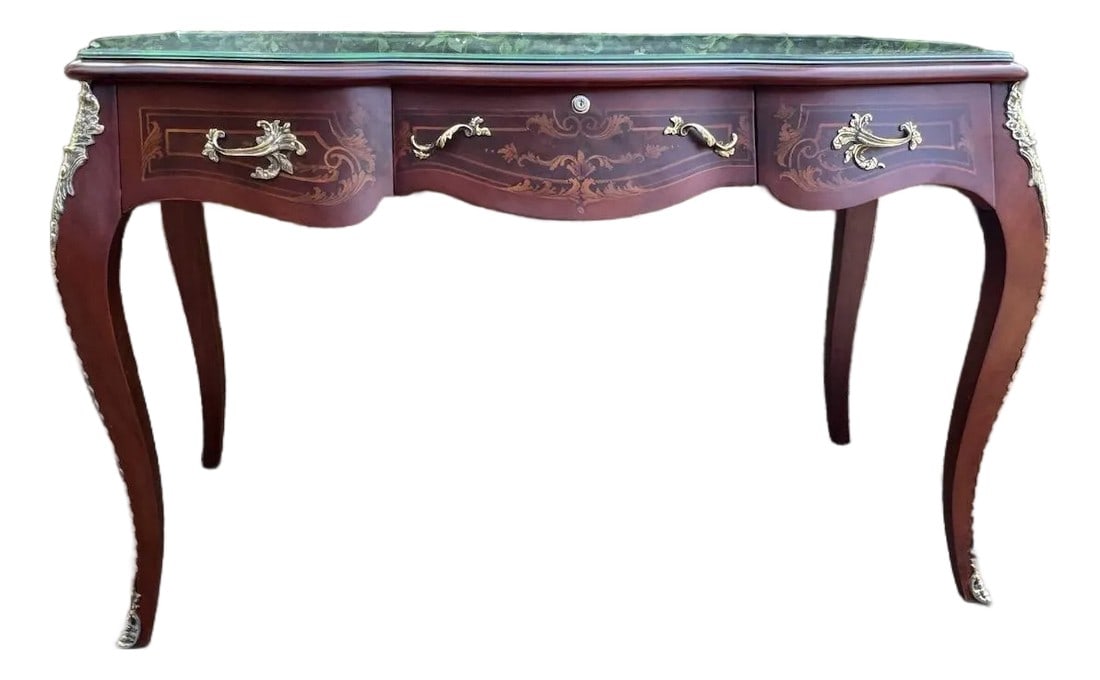 Circa 1970 French Louis XVI Mahogany Bronze Writing Desk: Date / Period: Circa 1970 Maker / Brand: Unknown French Maker Style: Louis XVI / Neoclassical Color: Warm Brown with Gilt Bronze Accents Material: Solid Mahogany Wood & Bronze Category: Desk /