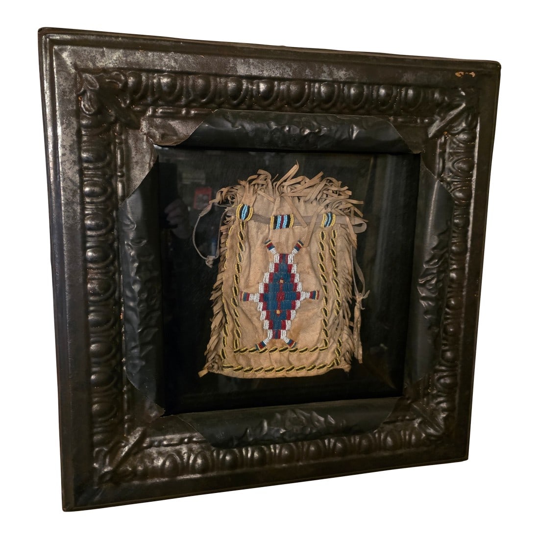 Framed American Indian Beadwork: Beautiful Native American Indian beadwork decorated shadowbox framed bag. The frame is a work of art. It is made using an authentic antique ceiling tile and the interior background is dark cowhide.