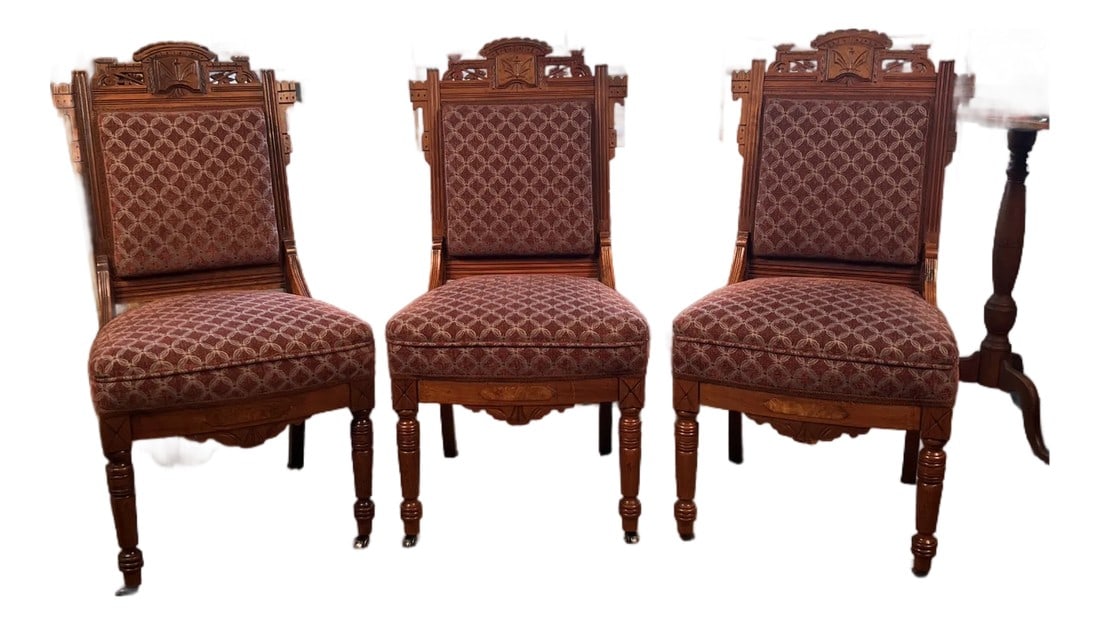 Set of Three 19th Century Eastlake Aesthetic Movement Walnut Parlor Chairs, Newly Upholstered: A handsome set of three late 19th century American Eastlake parlor chairs crafted in solid walnut. The chairs feature incised Aesthetic Movement carving, architectural crest rails, and turned front