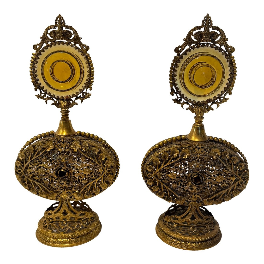 Pair of Antique Victorian Ormolu Perfume Bottles With Amber Glass and Original Daubers: An elegant matched pair of late 19th-century Victorian ormolu-mounted perfume bottles, each featuring an internal glass reservoir housed within an intricately pierced gilt metal stand. The ornate