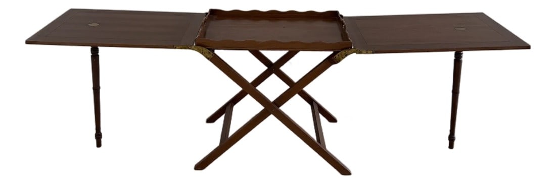 Late 20th Century British Colonial Style Mahogany Folding Tray Table With Brass Hardware: Handsome British Colonial–style mahogany folding tray table featuring a removable serving tray with scalloped gallery edges and integrated cut-out handles. The tray rests atop a classic X-form