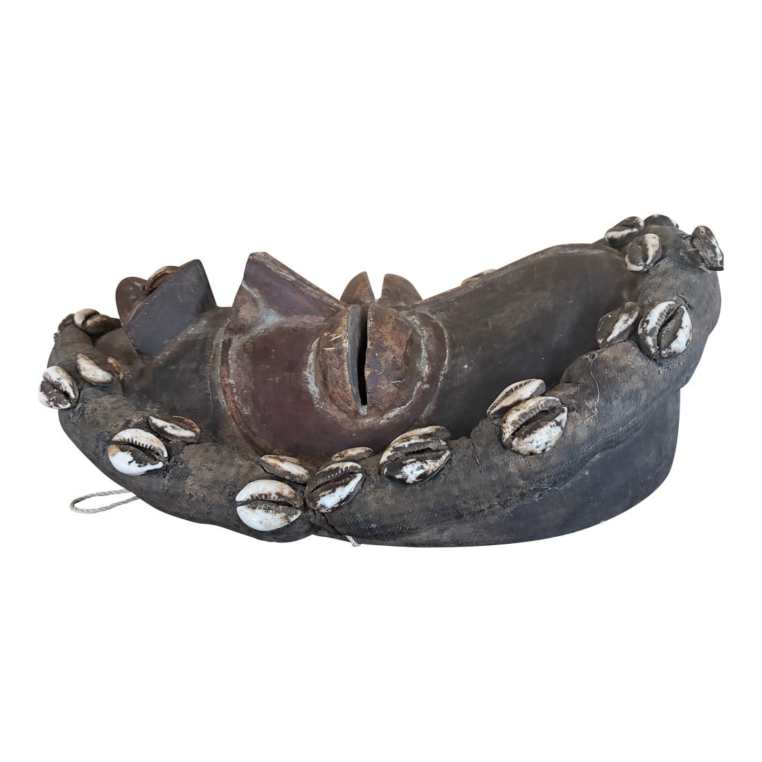 African Dan Mask 20th Century: This is African Dan mask from the Ivory Coast, from the 20th century. It is made of wood, cowrie shells and textiles. It shows signs of aging from the patina .it is predominantly black , but has some