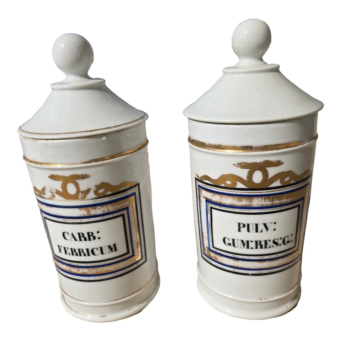 Pair of Antique Apothecary Jars: Beautiful pair of white porcelain antique apothecary jars from Europe. These have worn gold, blue and black details. One is stamped on the bottom and the other one is not. Condition: Alterations: