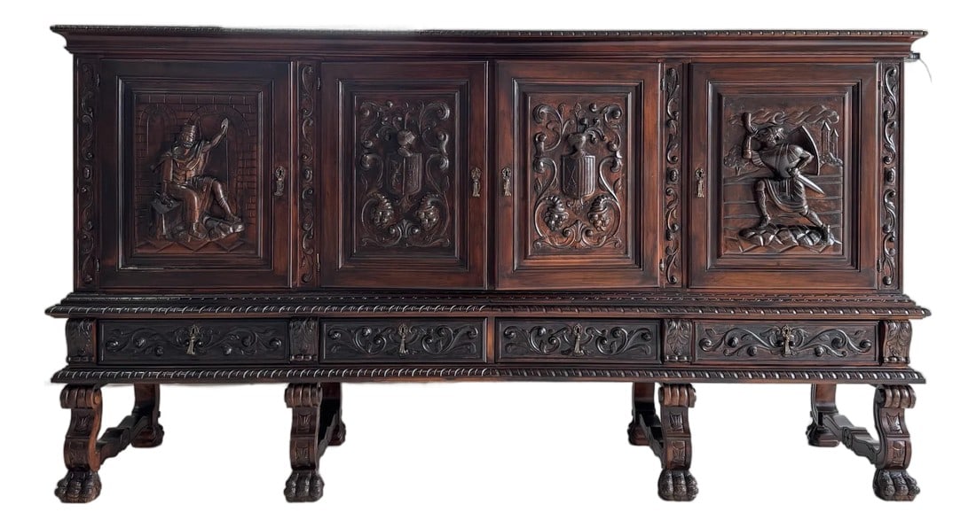 1950s Heavily Carved Spanish Style MCM Sideboard W/ All Keys: Acquired from an estate, this 1950s Heavily Carved Spanish Style MCM Sideboard showcases exceptional craftsmanship and dramatic carved detail. The original finish showed wear, so it was
