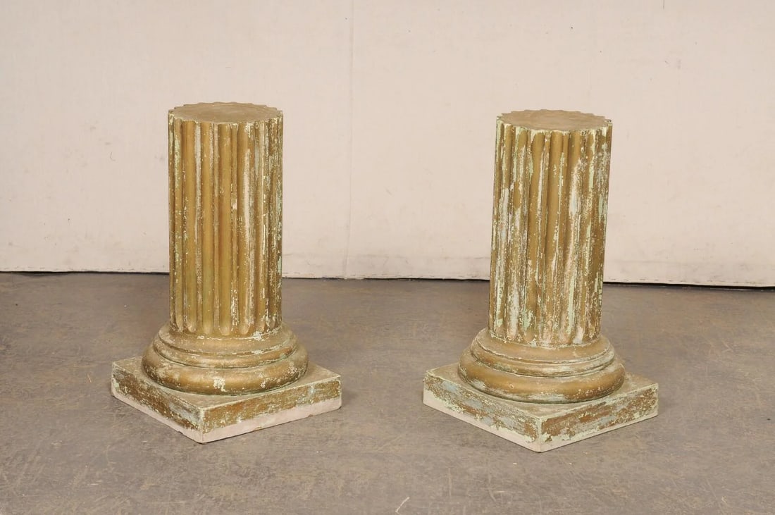 Mid 20th Century Fluted Column Pedestals - a Pair: A pair of vintage painted wood column pedestals. These pedestals each feature rounded bodies with fluted details, with lower regions wrapped in a series of rounded molding and raised upon