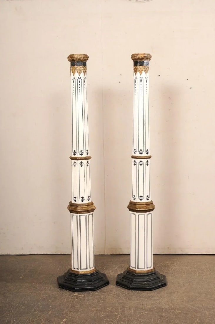 Spanish Tall Pair of Early 20th Century Columns: A Spanish pair of tapering, painted wood columns from the early 20th century. This tall pair of antique pillars from Spain, each with a hand-painted, decorative finish, have octagonal-shaped and