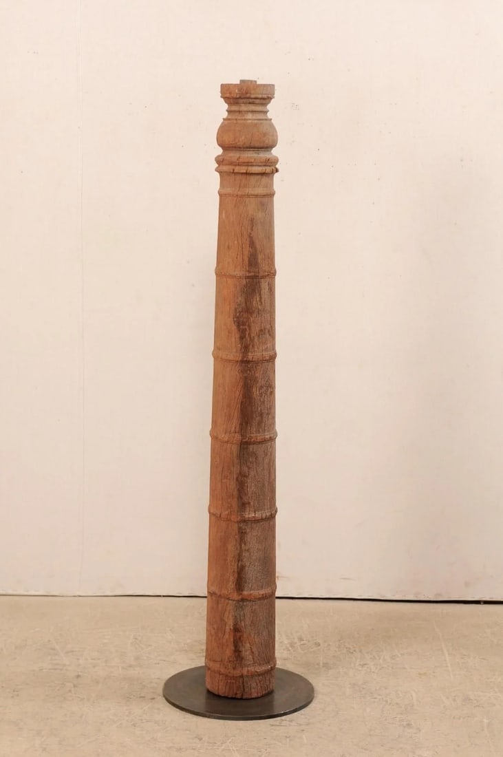 19th Century British Colonial Carved Wood Column on Stand: A single 19th century British Colonial carved wood column with custom stand. This antique hand-carved wooden architectural element from India, which stands approximately 5.5 feet in height, features a