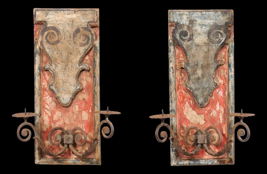 19th Century Italian Wall Mounted Candle Sconces - A Pair: A pair of Italian painted wood wall plaques with iron candle arms from the 19th century. This antique pair of wall decorations from Italy were created with 19th century wall plaques, with vintage