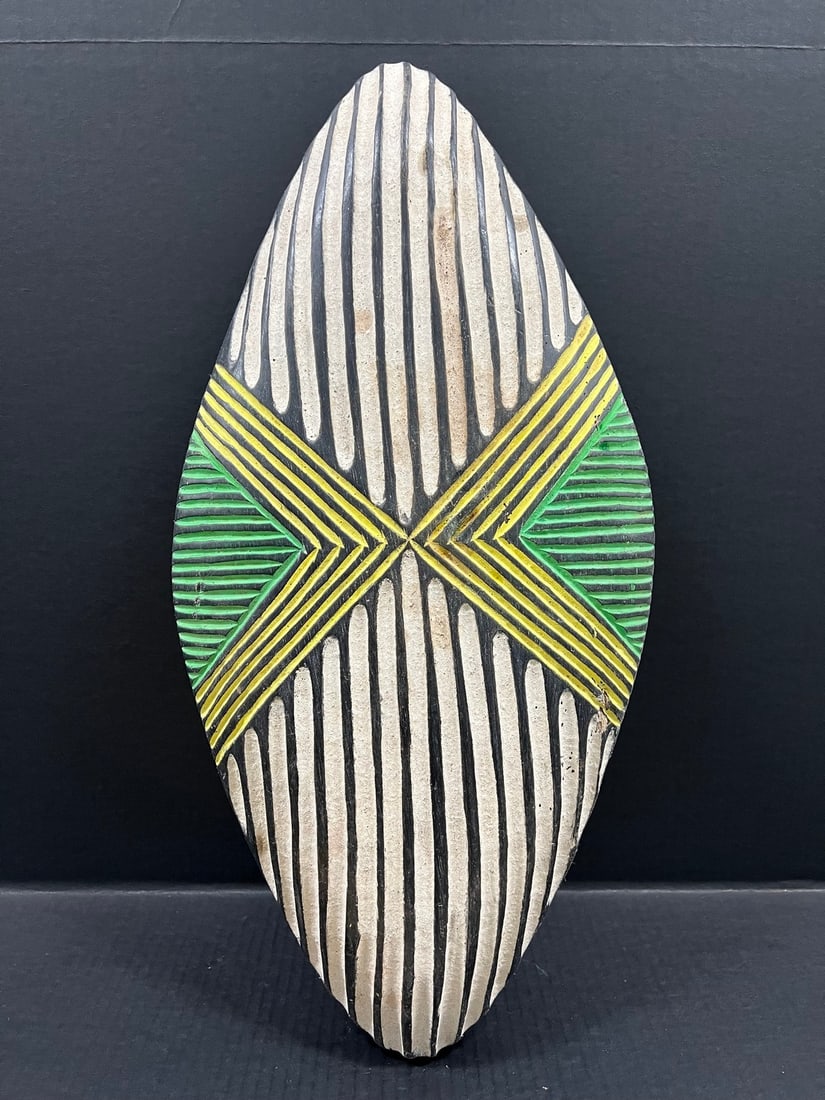Zulu Shield: Title: Zulu Shield Description: African Tribal Art Zulu Shield Date/Period: Late 20th Century Materials: Wood Size: 24.5" h x 12" w Reserve: $300.00 Shipping:Domestic: Flat-rate of