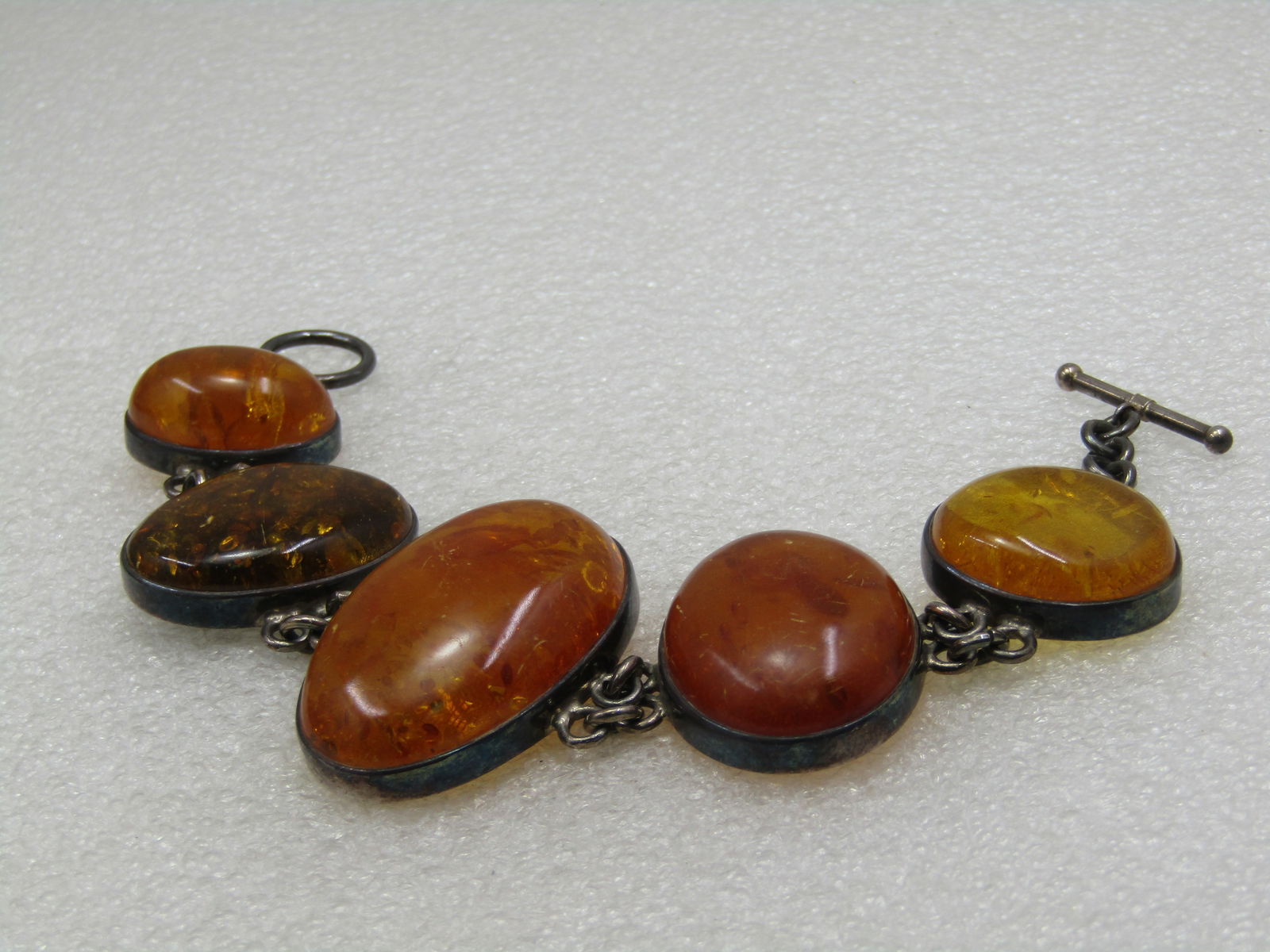 Vintage Sterling Amber Bracelet, 8", Toggle Clasp: Vintage Sterling Amber Bracelet, 8", Toggle Clasp. There are 5 links with the largest in the center that is slightly over 1.5" long, the n the next on each side are appx. 1.25" with the end links