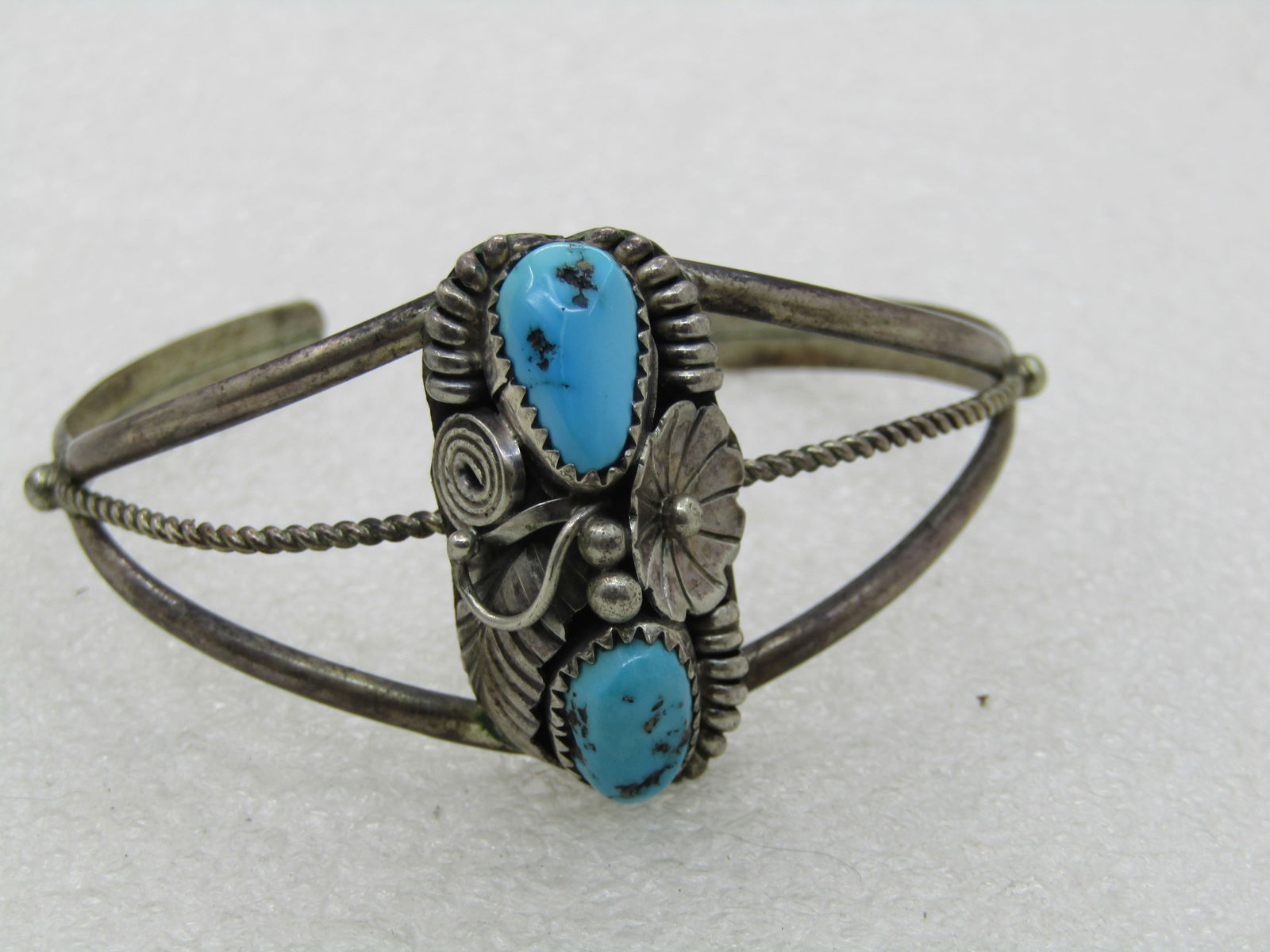 Vintage Sterling Southwestern Turquoise Cuff Bracelet, 6.75", 1960's-1980's: Vintage Sterling Southwestern Turquoise Cuff Bracelet, 6.75, 1960's-1980's, weight is appx. 15.23 grams. It has two oval-ish turquoise nuggets that are appx. 13mm and 10mm long, sawtooth bezel-set