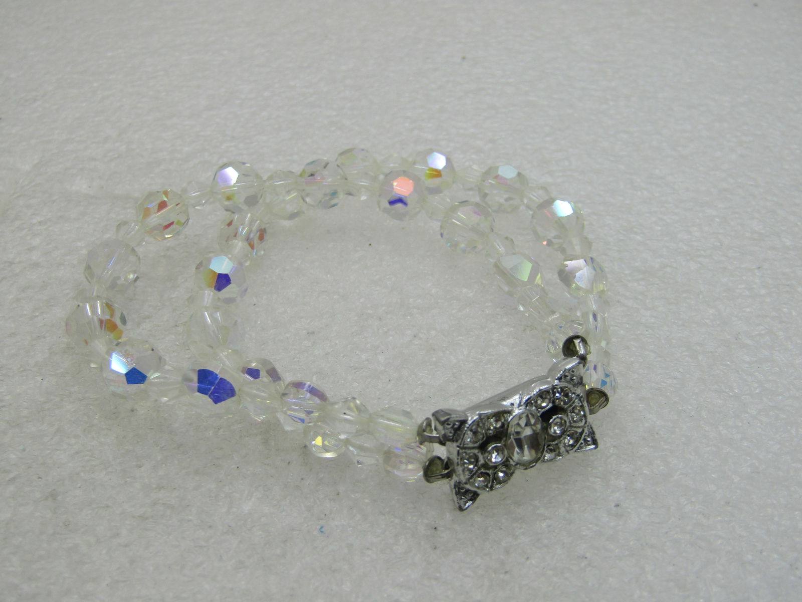 Vintage Double Strand Crystal Beaded Bracelet, 7.5", Aurora Borealis: Vintage Double Strand Crystal Beaded Bracelet, 7.5", Aurora Borealis, Art Deco with fancy rhinestone rectangular ornate clasp. Ppxz. 1/2" wide with round 7.5mm beads and diamond-shaped beads between.