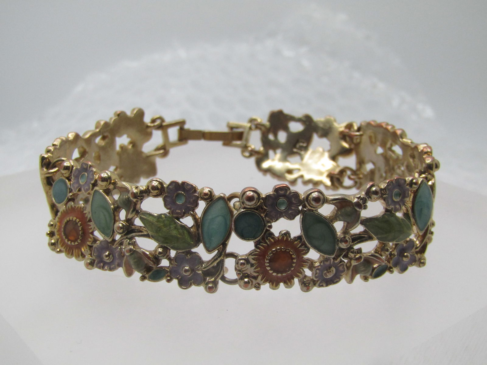Vintage Enameled Floral Bracelet, 7.25", 1990's. Liz Claiborne: Vintage Enameled Floral Bracelet, 7.25", 1990's. Liz Claiborne. It is appx. 5/8" wide with flip clasp. Silver tone and gold tone with enameled orange sunflowers lavender blossoms and little bees