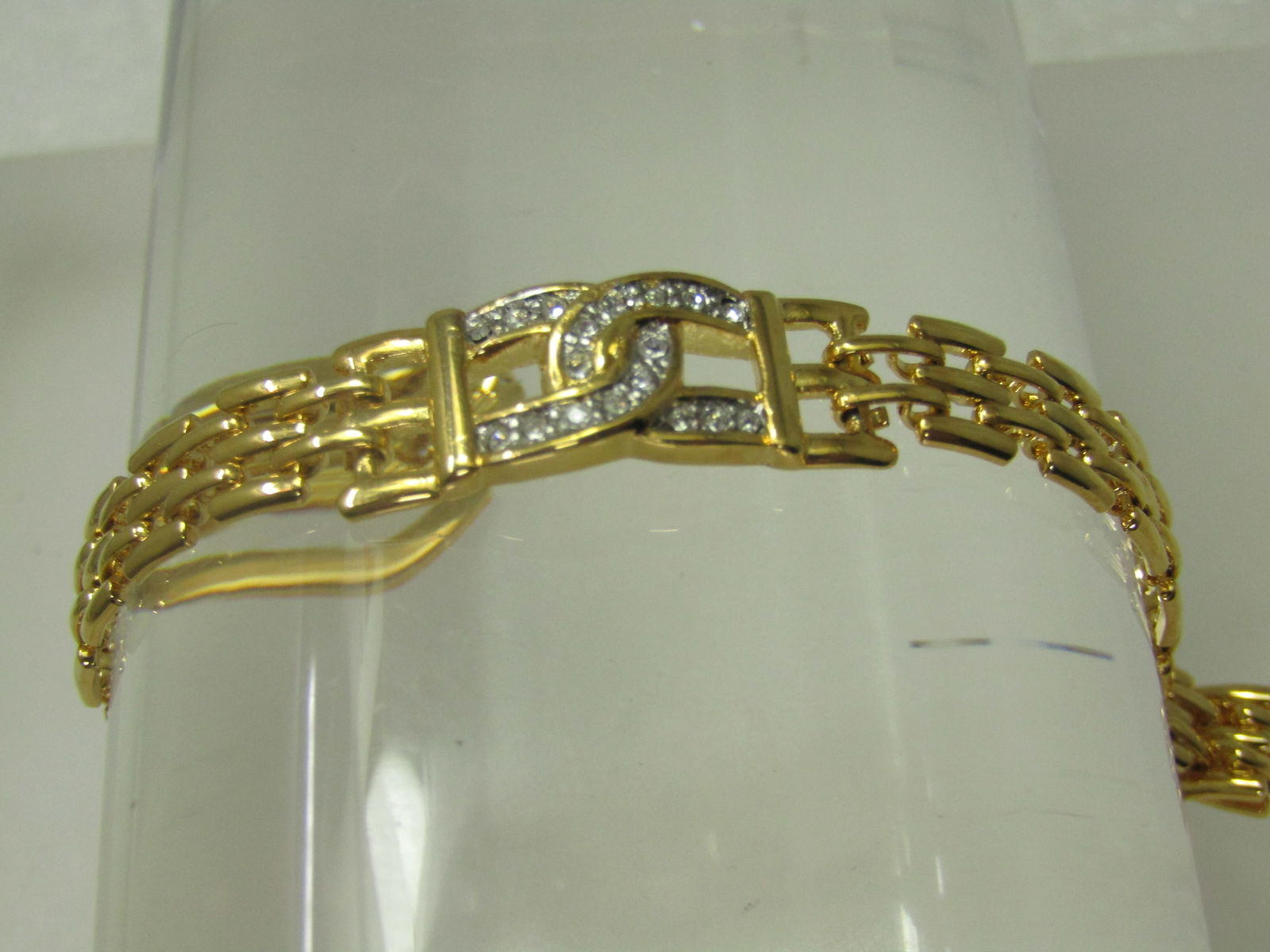Vintage Woven Bracelet, Double Rhinestone Horseshoe Accent, 7.25": Vintage Woven Bracelet, Double Rhinestone Horseshoe Accent, 7.25". Appx. 1/2" at center and 3/8" at the woven link. Gold tone. Flip clasp. 1980's-1990's. Not signed by the maker. The center is