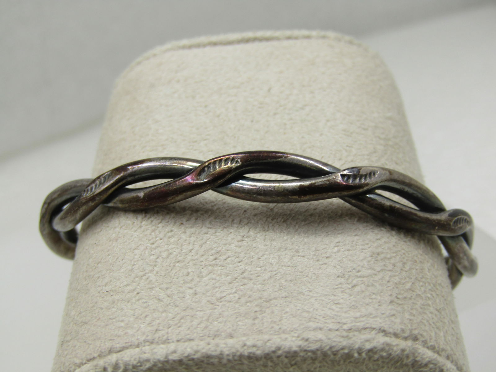 Vintage Sterling Intertwined Southwestern Stamped Cuff Bracelet 6.5": Vintage Sterling Intertwined Southwestern Stamped Cuff Bracelet 6.5" and appx. 7mm wide (varies slightly) at the widest point and then with it crosses over appx. 3.5mm to 4mm. It is handmade and