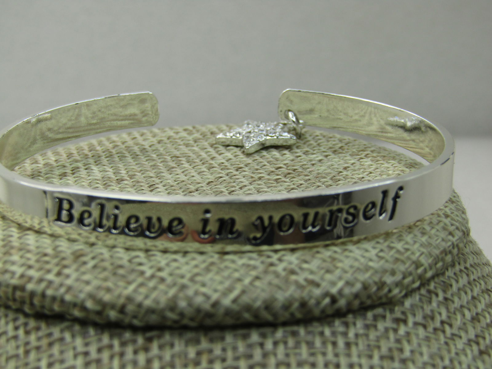 Avon My Truth Charm Cuff Bracelet, 6.75" Believe in yourself with Rhinestone Star: Avon My Truth Charm Cuff Bracelet, 6.75" Believe in yourself with Rhinestone Star. 2015, new in box with Sleeve. 6mm wide silver tone cuff with a 5/8" dangle rhinestone star at the back on one side.