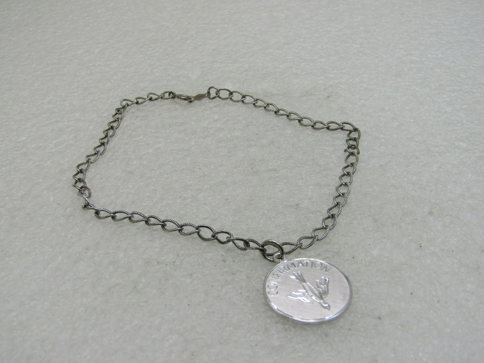 Vintage Sterling Silver Ankle Charm Bracelet, Confirmation Charm, 9.5", 1960'S: Vintage Sterling Silver Ankle Charm Bracele 1960'S, Confirmation Charm, 9.5", 4.98 grams, signed BLI. Marked .925 and tsted. This has a 7/8" round confirmation charm with diamond cut dove image. The a