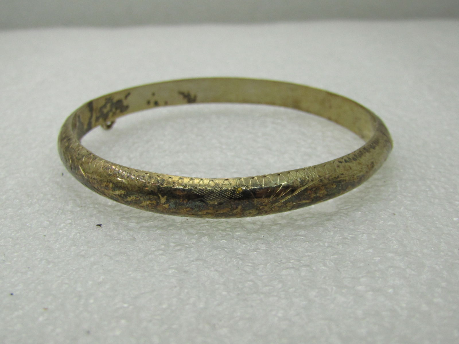 Vintage Sterling Silver Engraved Bangle Bracelet, 7.25", 6.5mm: Vintage Sterling Silver Engraved Bangle Bracelet, 7.25", 6.5mm. Weight is appx. 8.40 grams. Scrolled leaf like markings around the bracelet, marked .925 and tested. Not signed by the maker. Does not