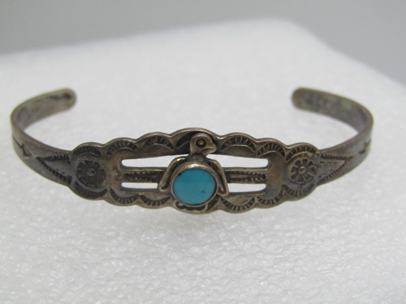 Vintage Sterling Southwestern Turquoise Thunderbird Cuff Bracelet, Youth, 5": Vintage Sterling Southwestern Turquoise Thunderbird Cuff Bracelet, Youth, 5". This has a round bezel-set turquoise stone that is appx. 5.5mm round set over the torso fo the thunderbird that is set