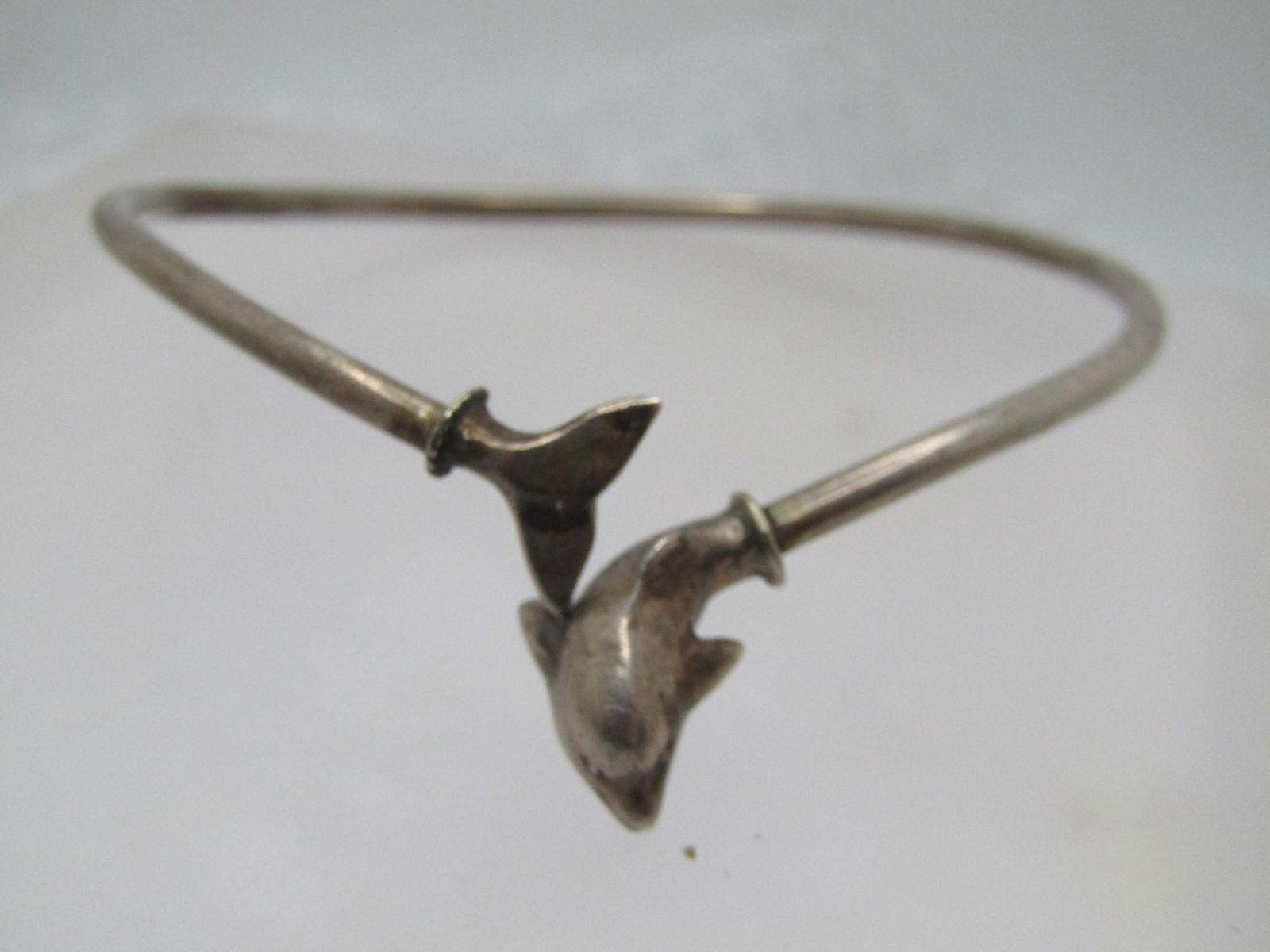 Vintage Sterling Wrapped Dolphin Bangle Bracelet. 7.75" , 1970's, Signed: Vintage Sterling Wrapped Dolphin Bangle Bracelet. 7.75" , 1970's, Signed with two marks I cannot read. The measurement is 7.75" and the opening is appx. 2.5" across. The tail is on one side and the