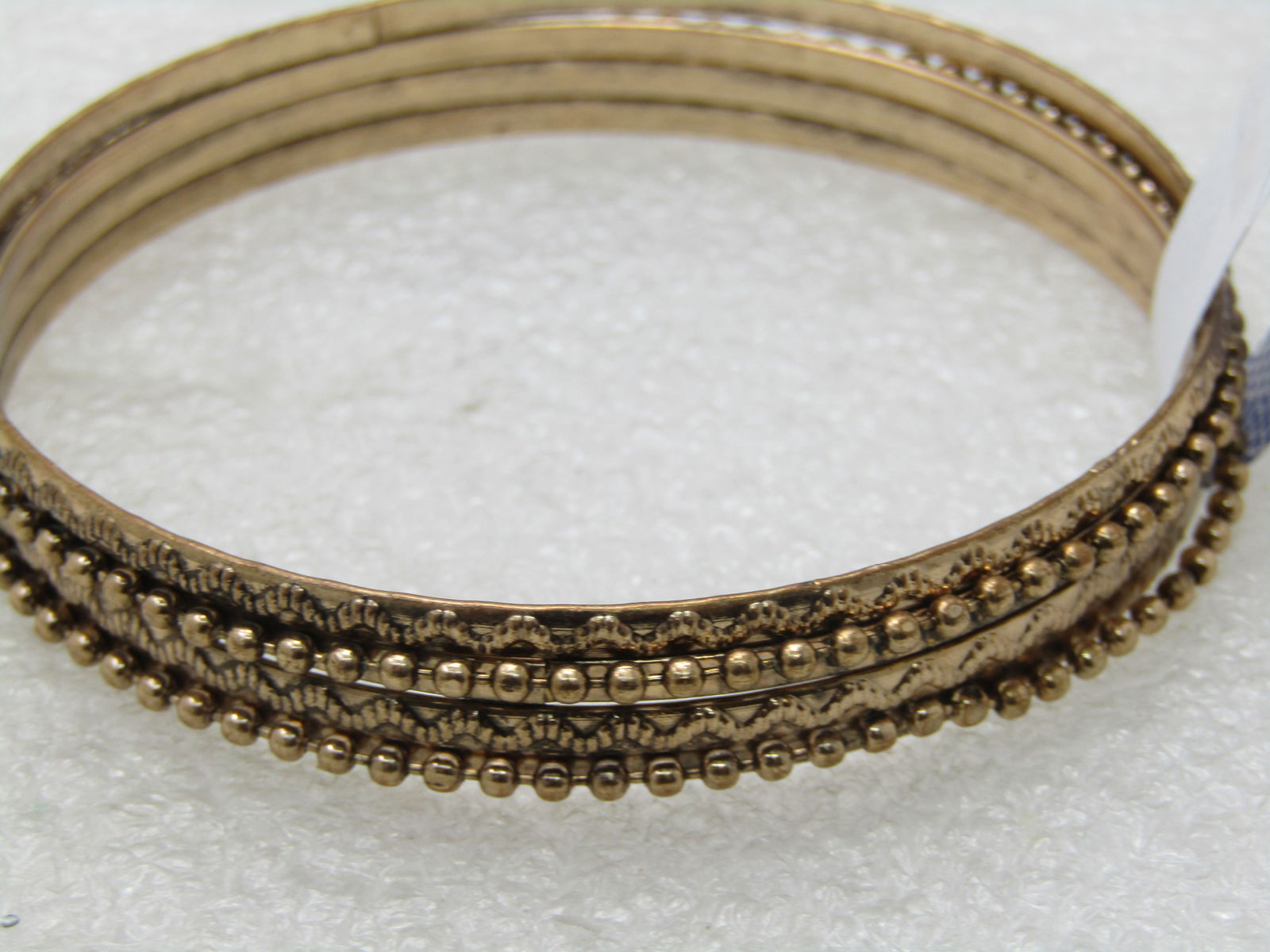 Vintage Layered & Stacked Bangle Bracelet, 8", Gold tone: Vintage Layered & Stacked Bangle Bracelet, 8", Gold tone - four think stacking bangle bracelets fused into a single bracelet with textured raised accents on two and a beaded chain raised on the other