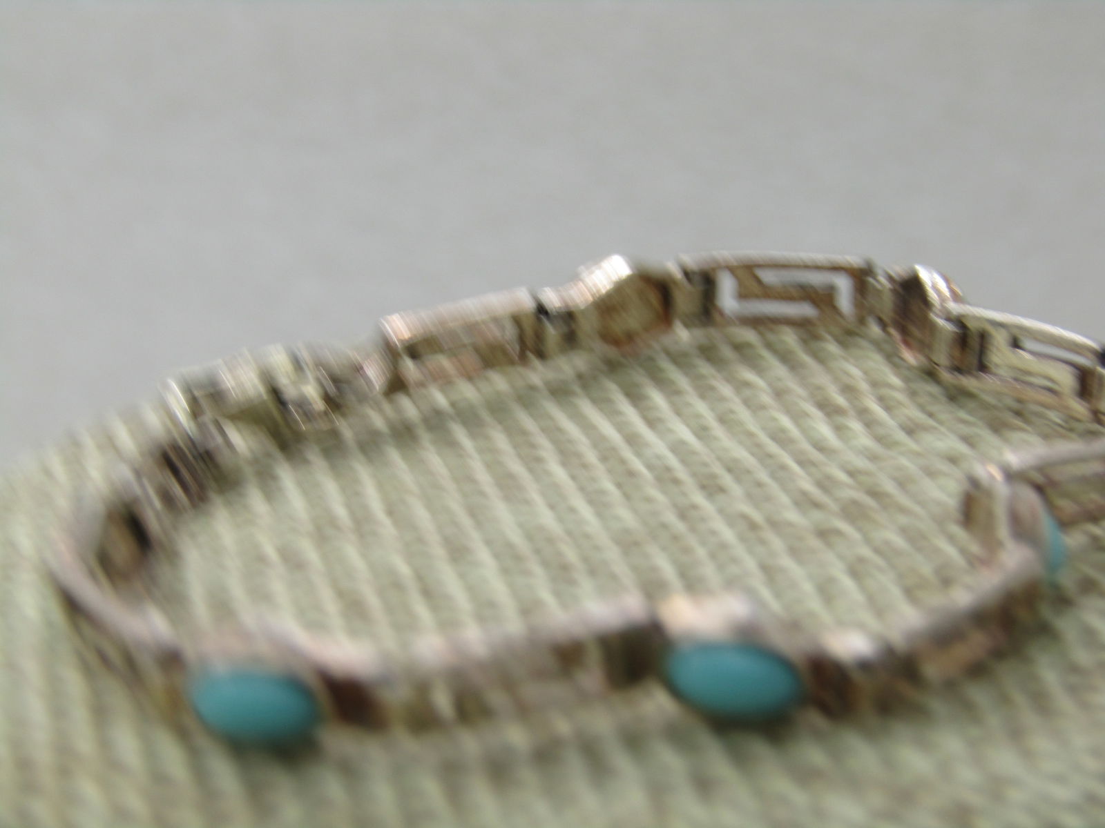 Sterling Silver Turquoise Glass Bracelet, Open Link, 7", 4.5mm to 5.5mm Wide: Sterling Silver Turquoise Glass Bracelet, Open Link, 7", 4.5mm to 5.5mm wide. The links between the oval turquoise glass stones have a Greek key look but are an L-7 cut-out design. Lobster calsp.