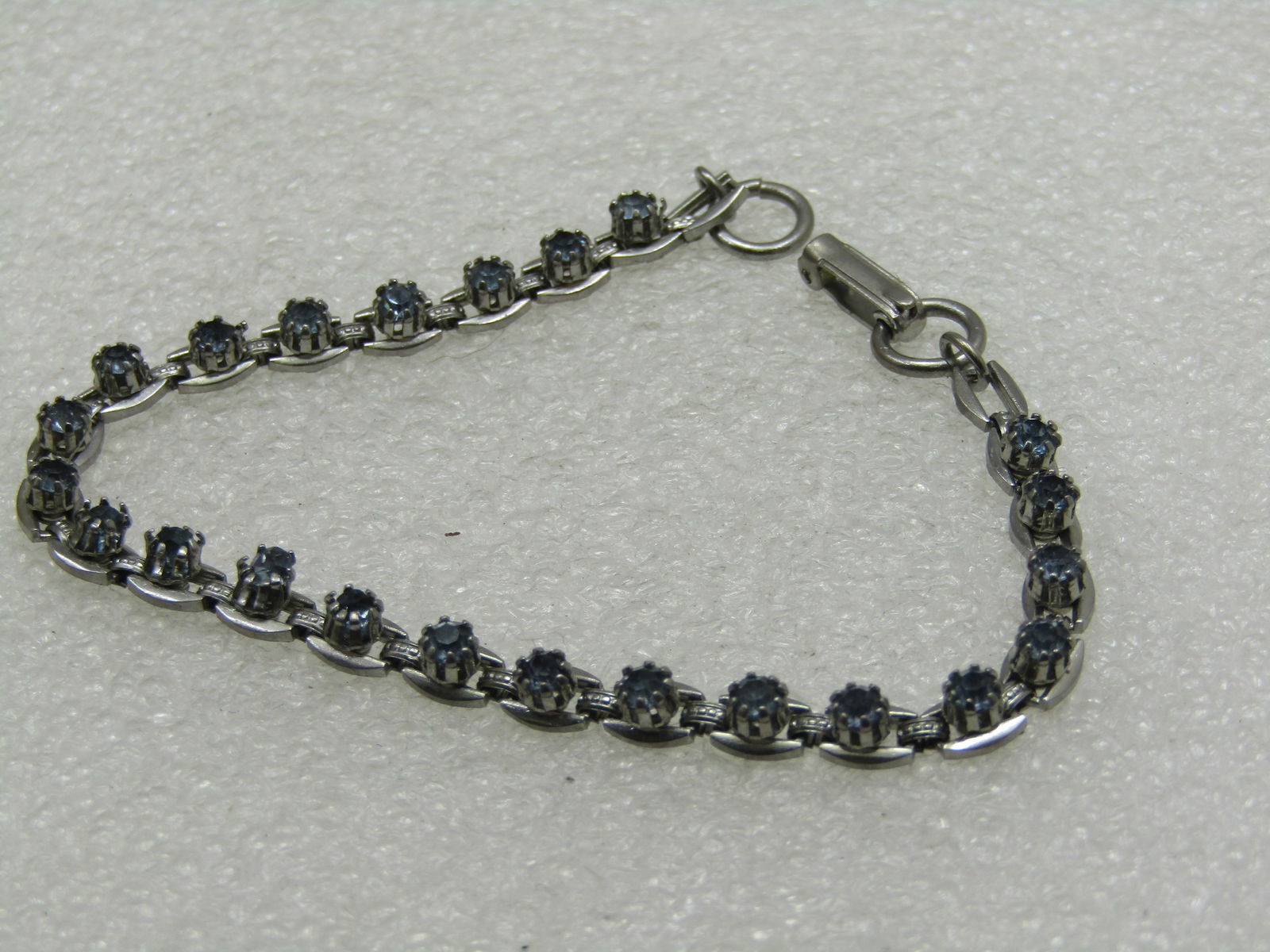 Vintage Blue Rhinestone Tennis Bracelet, 7.25", 1970's-1980's: Vintage Blue Rhinestone Tennis Bracelet, 7.25", 1970's-1980's, 4.5mm wide, hinged flip clasp. Oval links with raised appx. 3mm wide. Good condition. Not signed by the maker. (INV. W.5121.6 SS4629 J LD