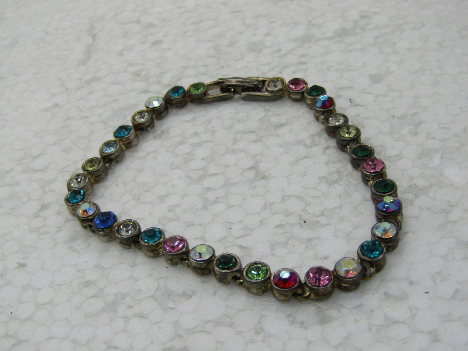 Vintage Colorful Rhinestone Tennis Bracelet, 7.5", Aurora Borealis: Vintage Colorful Rhinestone Tennis Bracelet, 7.5", Aurora Boreali, round stones set in round bezels, in clear pink, blue, green, red - some are aurora borealis and some sit higher than the others. Gol